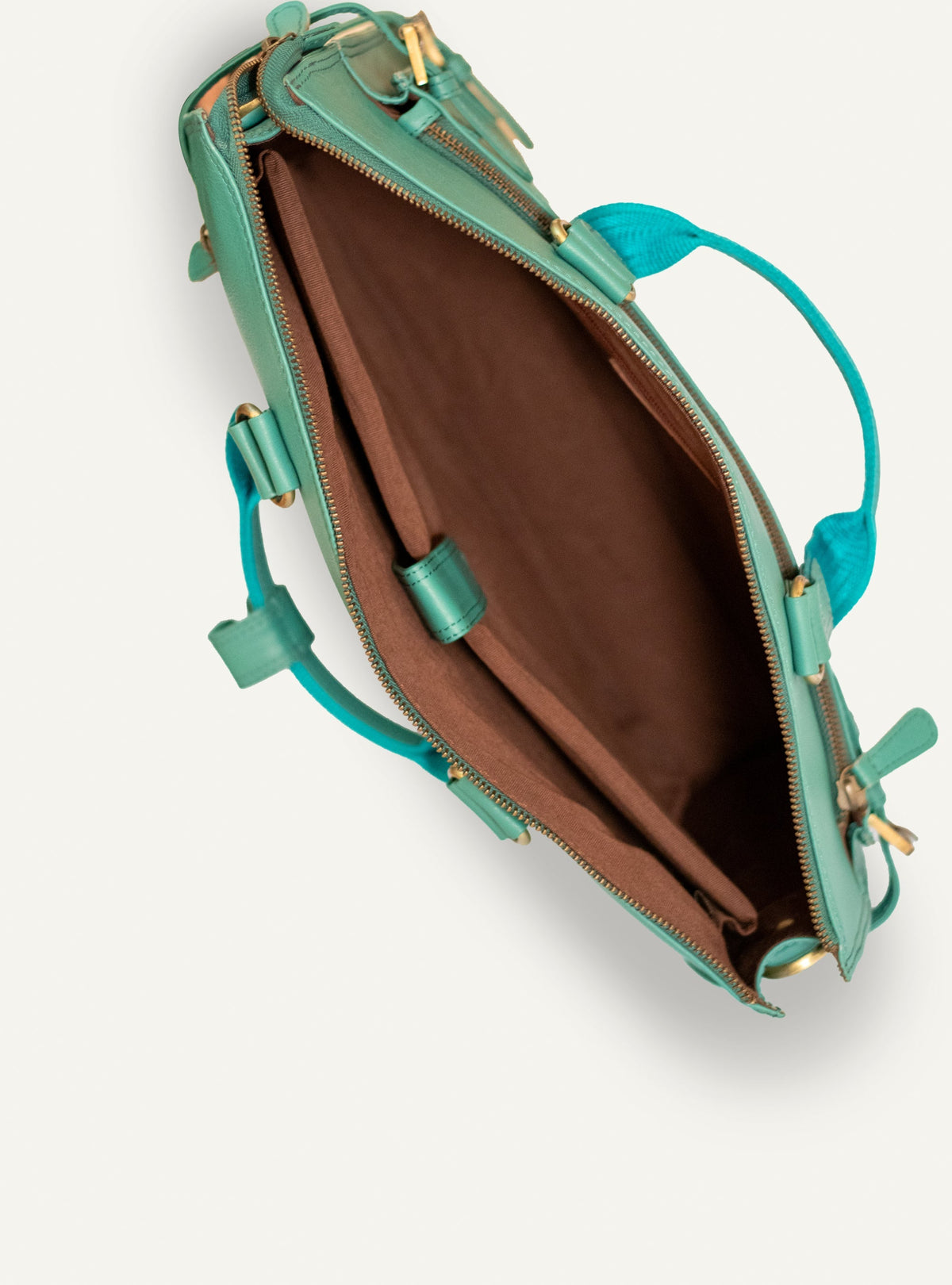 Interior of the teal Albert briefcase showing the fabric lining and padded divider