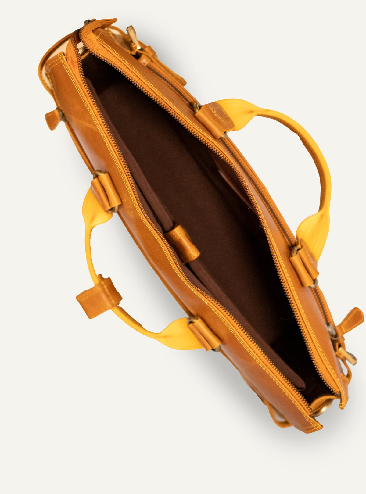 Interior of the mustard Albert briefcase showing the fabric lining and padded divider