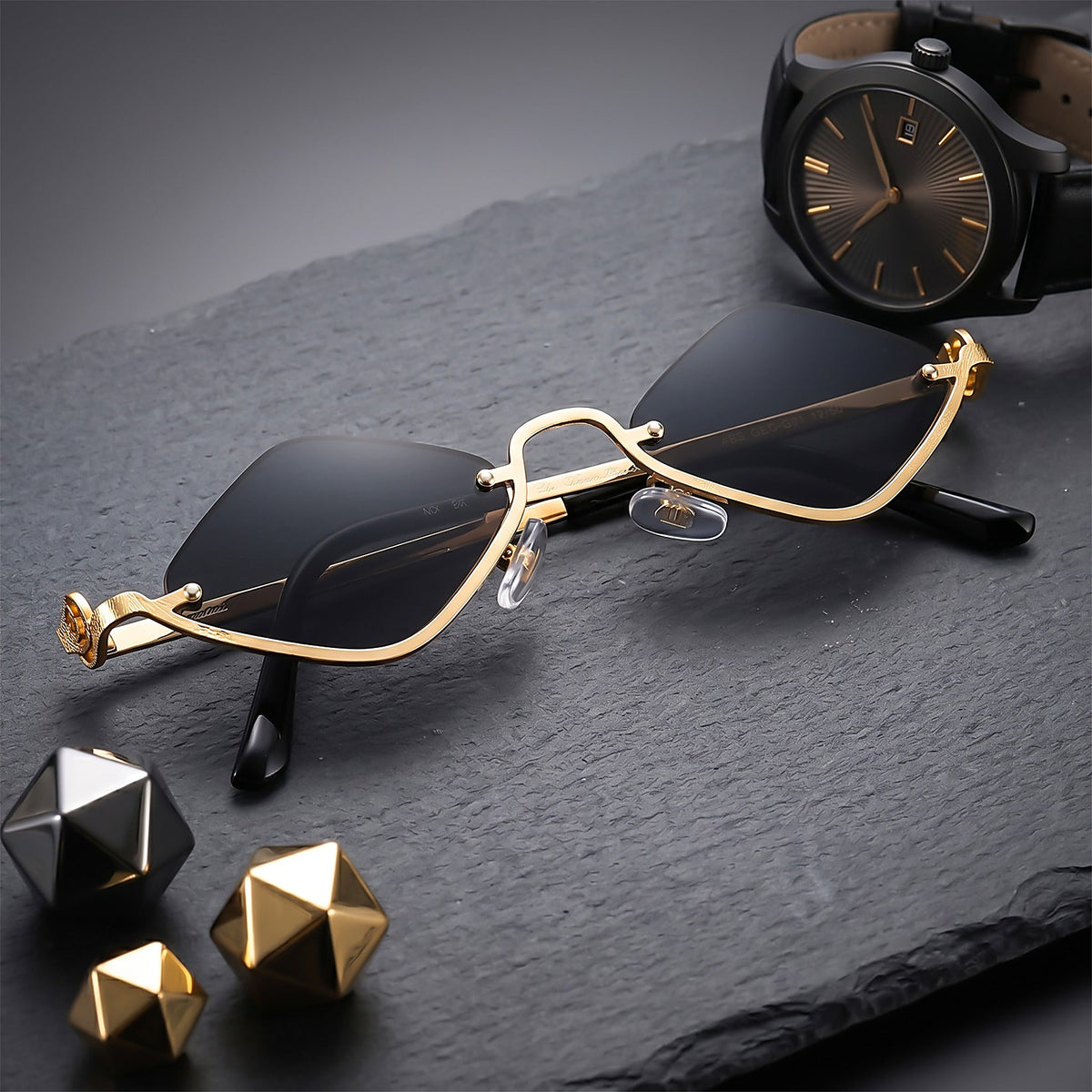 ROSHFORT gold faceted sunglasses styled with a watch on slate
