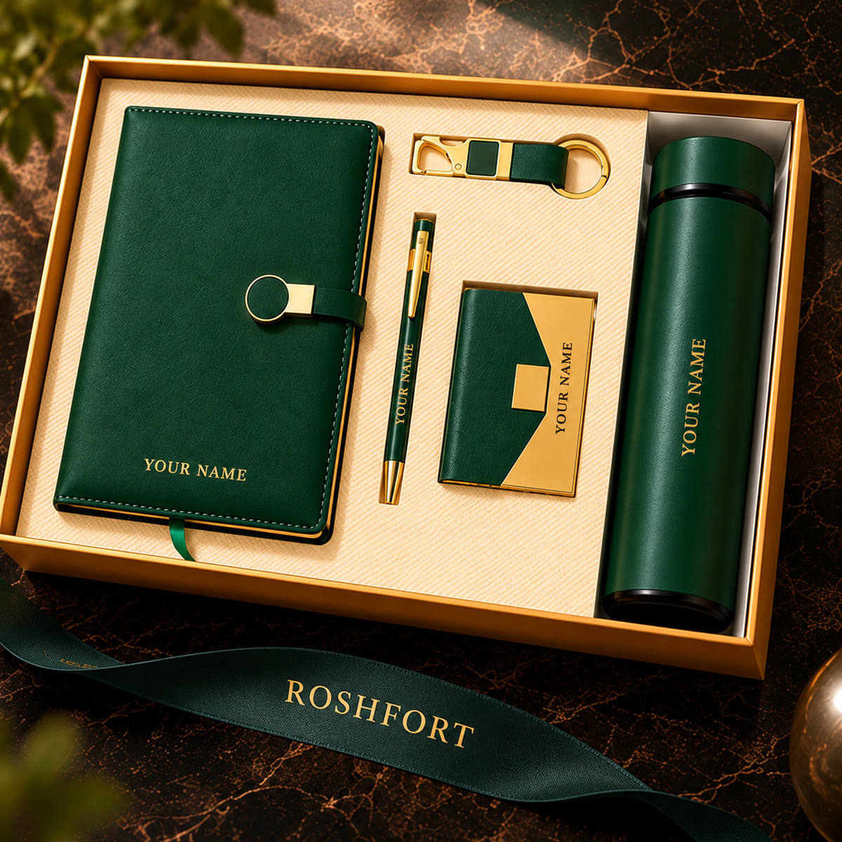 Green five-piece gift set in an open box, with sample name text visible on the diary, card holder and flask.