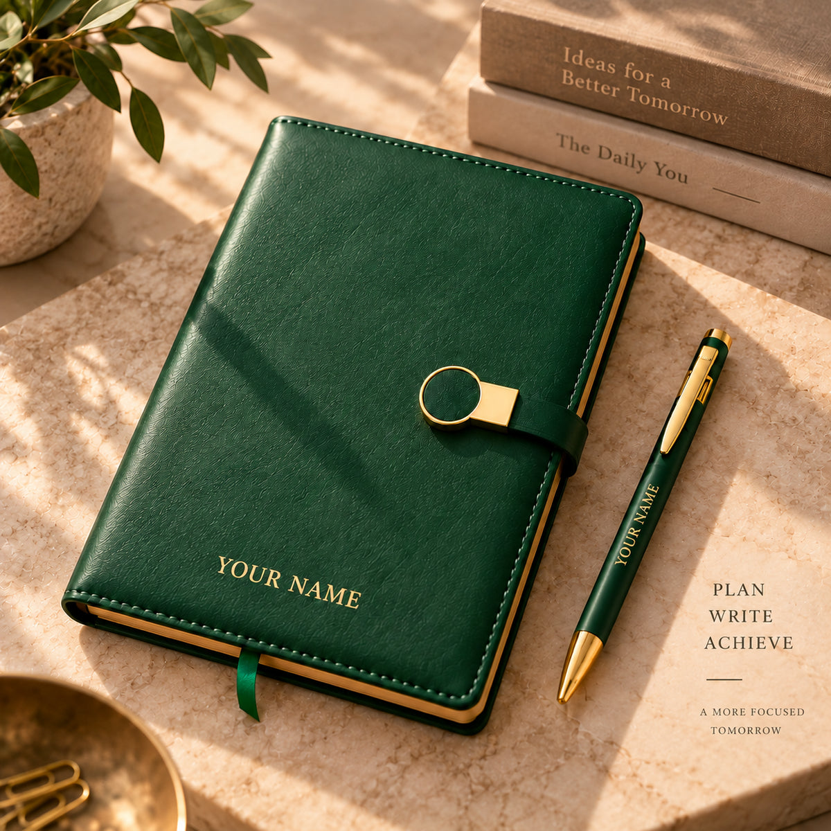 Green diary and matching pen displaying sample name personalisation on a sunlit desk.