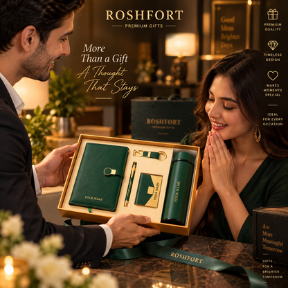 A man presents an open green gift-set box to a smiling woman, with the diary, pen, flask, card holder and keyring visible.