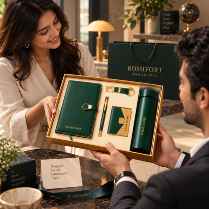 A woman and man hold an open green gift-set box with sample name lettering visible on several pieces.
