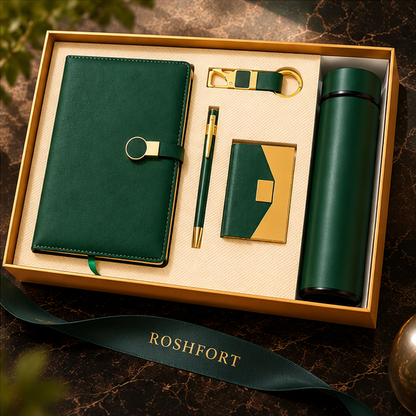 Green five-piece gift set with diary, pen, flask, card holder and keyring arranged in an open gold-tone presentation box.