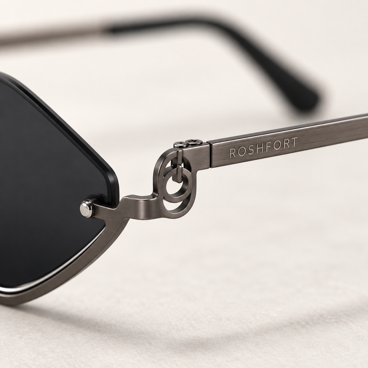 Close-up of ROSHFORT laser engraved on the temple of the Noir Facet sunglasses