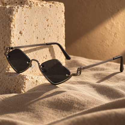 ROSHFORT Noir Facet sunglasses against a travertine block, ROSHFORT engraved on the temple