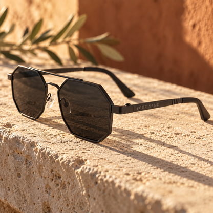ROSHFORT Noir Hexa personalised sunglasses on a limestone ledge, your name engraved on the temple
