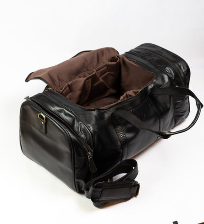 The black Amsterdam duffle held open with the detachable padded shoulder strap alongside