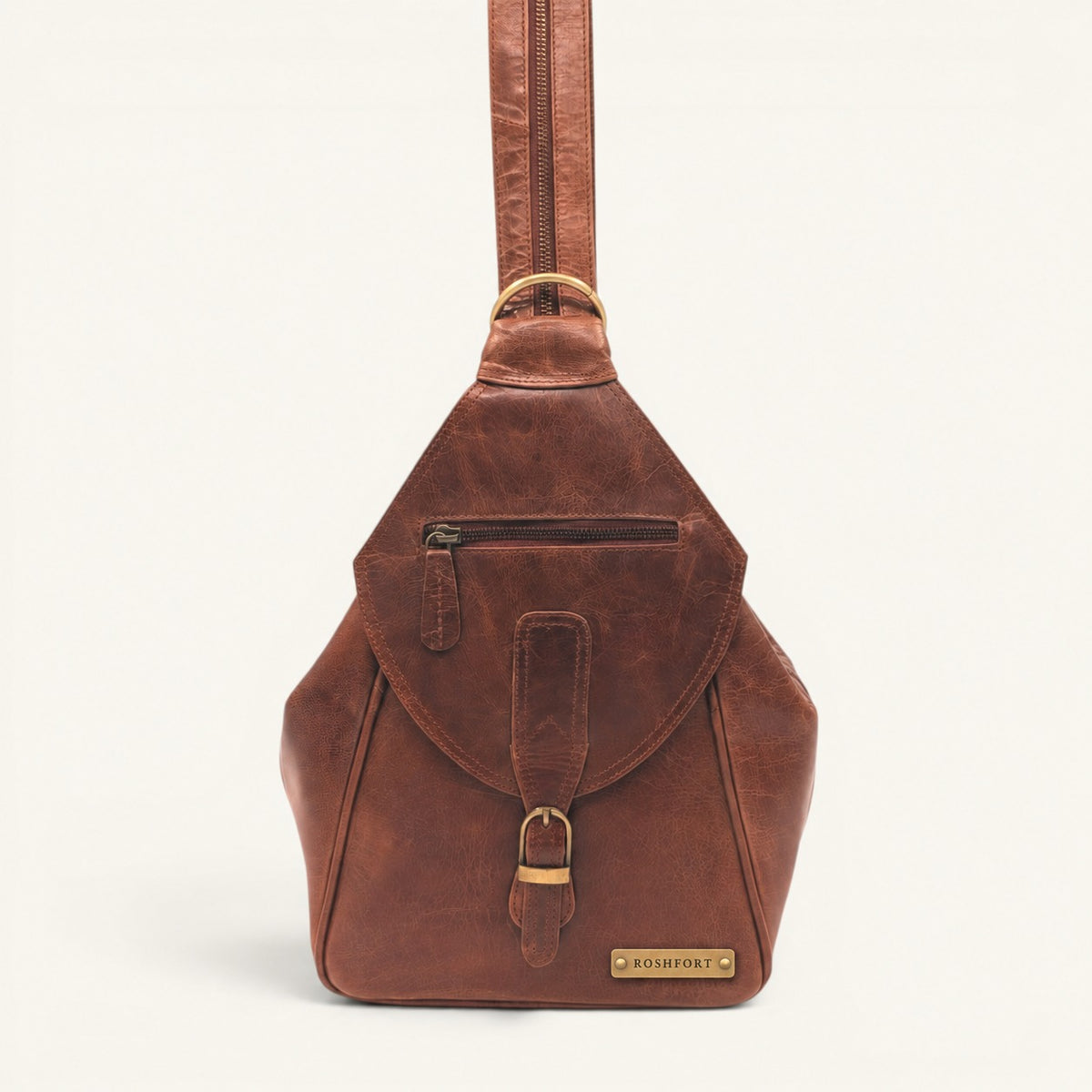 ROSHFORT Activa sling backpack in tan cognac crunch leather, front view with engraved brass name plate