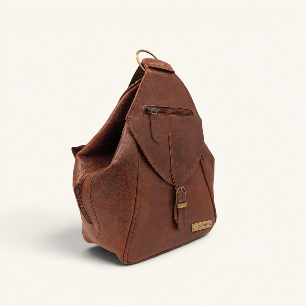 ROSHFORT Activa leather sling backpack, three-quarter side view showing depth and side zip