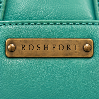 Close-up of the brass plate on the teal Albert briefcase - this is where your name is engraved