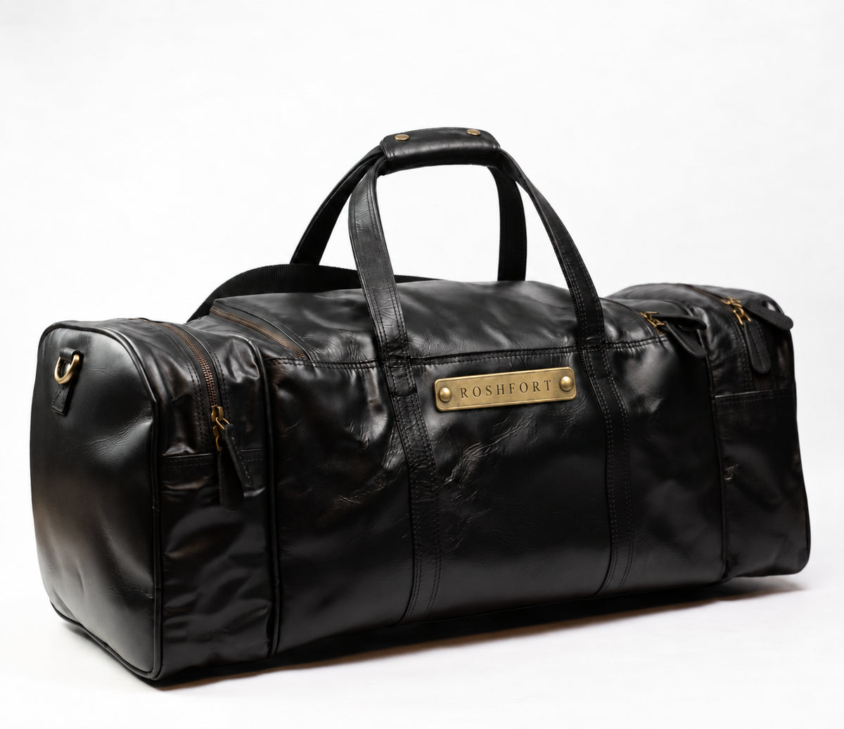 ROSHFORT Amsterdam leather weekender duffle in black, three quarter view with carry handles and brass ROSHFORT name plate