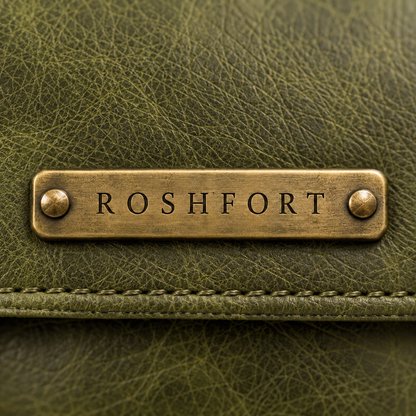 Close-up of the aged brass ROSHFORT name plate on the olive leather flap