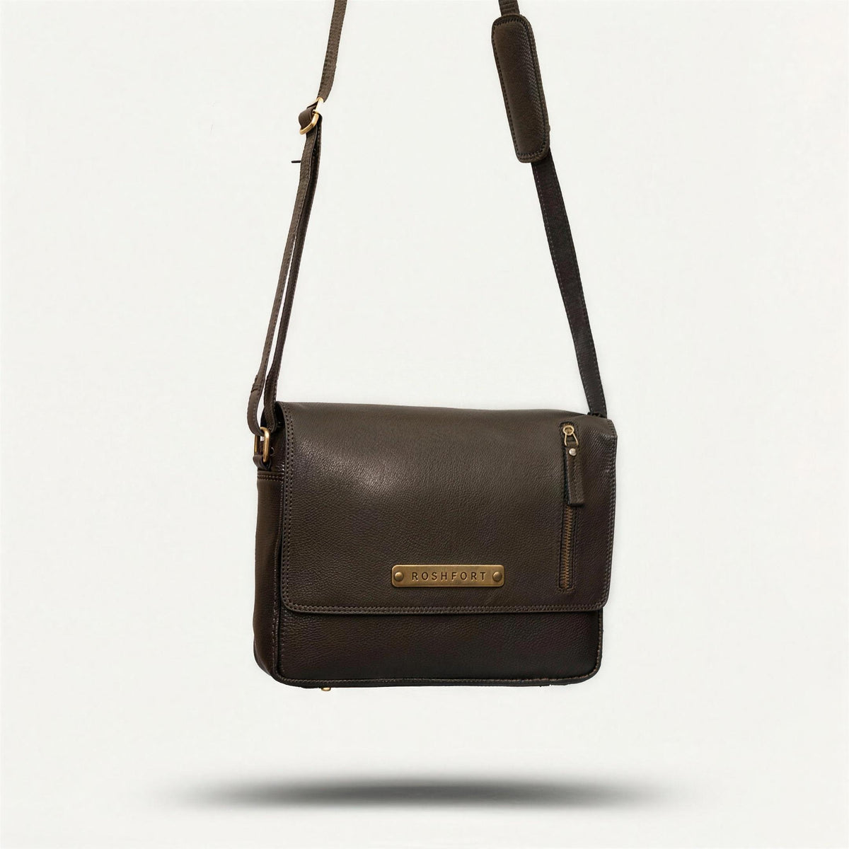 ROSHFORT Vince Cort black leather messenger bag hanging by its strap